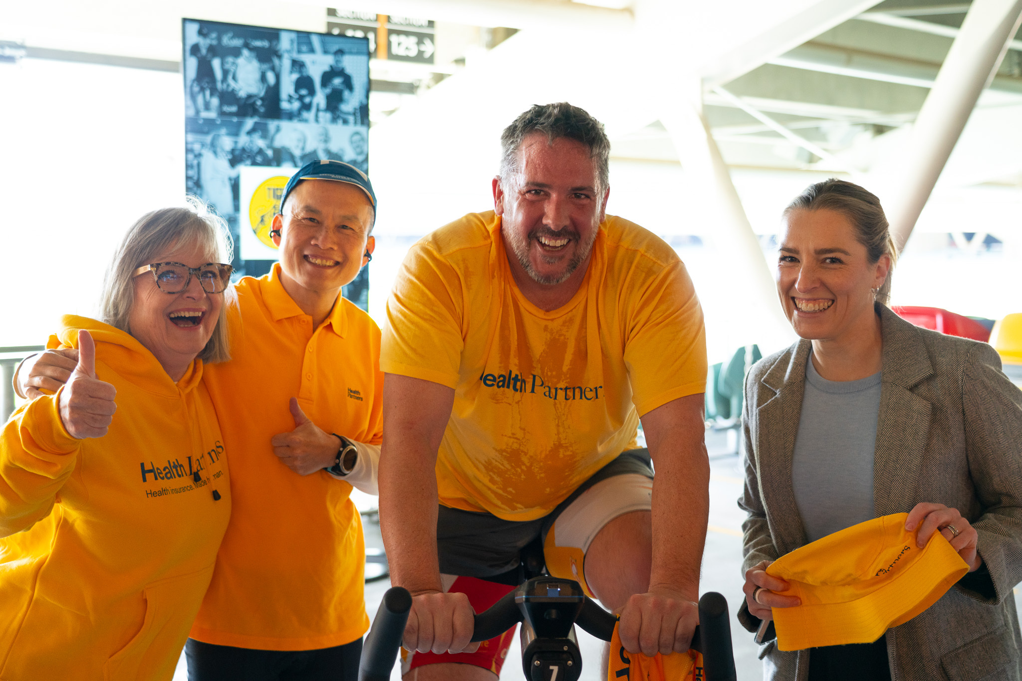 health partners team members around pedal to fight parkinsons stationary bike