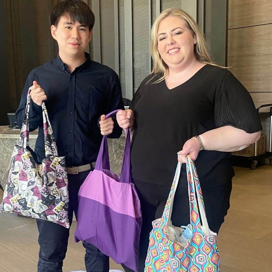 Two people holding escape bags